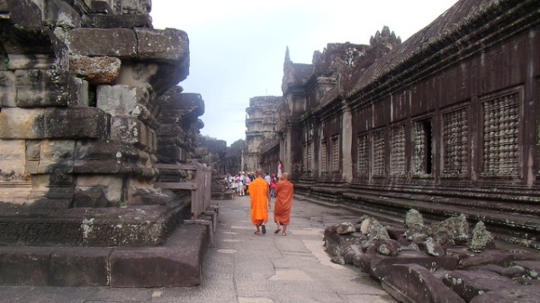Buddhist monks stroll through the temple